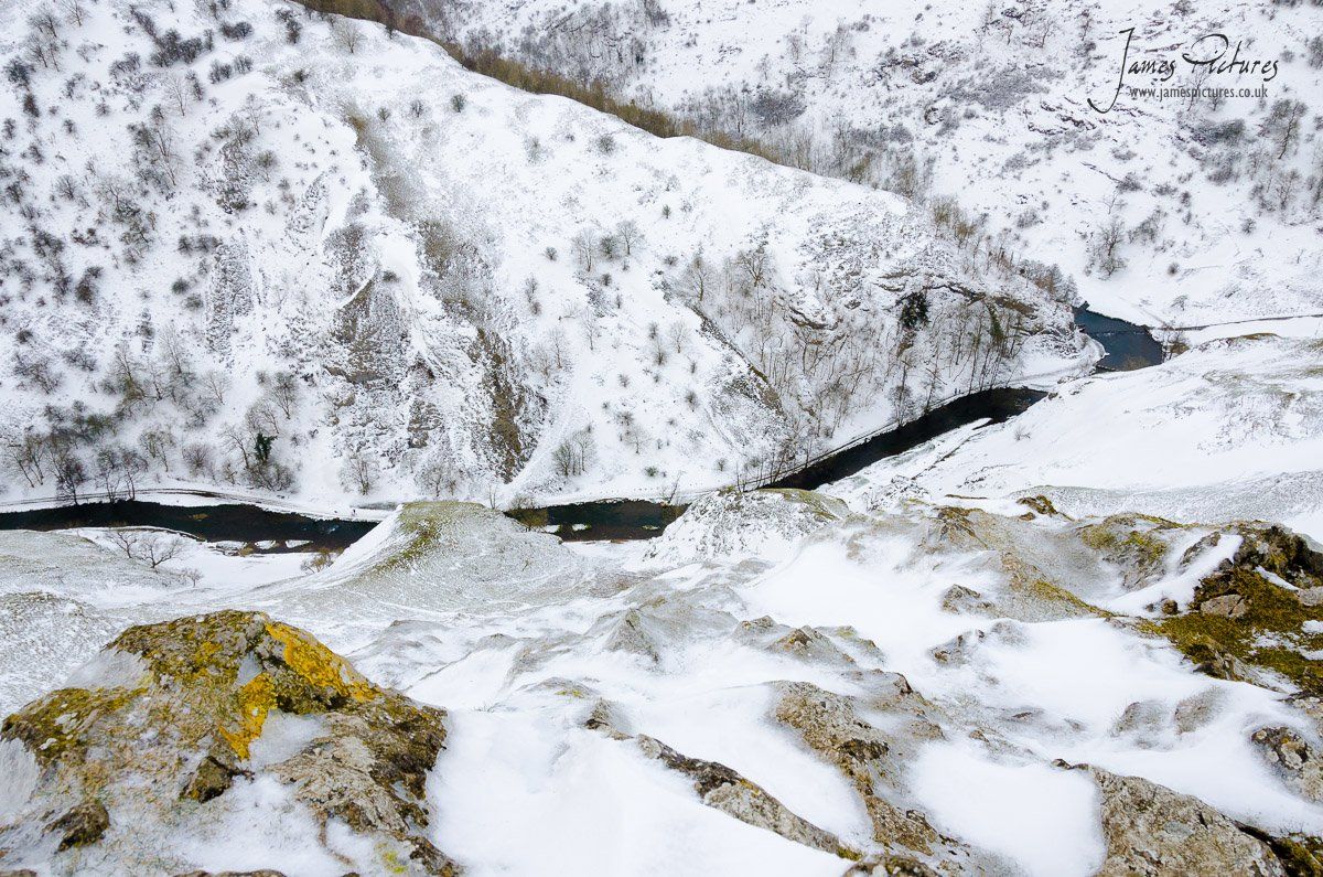 A snowy view from the top of Thorpe Cloud looking down onto the River Dove