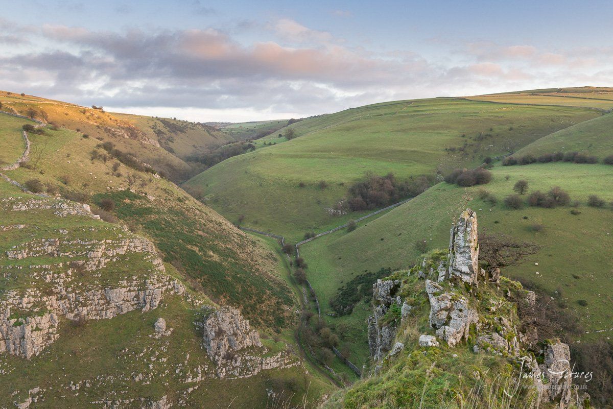 The morning sun hits the top of Biggin Dale in the Peak District. And a 7ft Limestone Pinnacle dominates the foreground.
