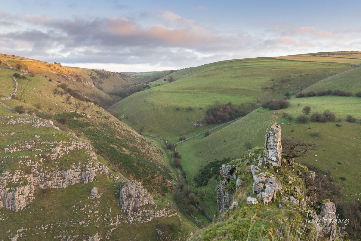 The morning sun hits the top of Biggin Dale in the Peak District. And a 7ft Limestone Pinnacle dominates the foreground.