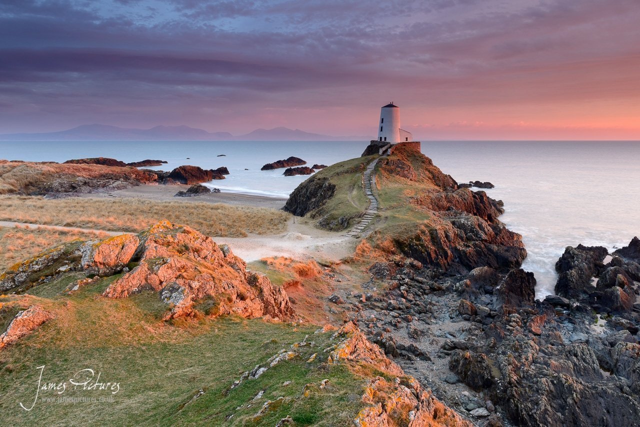 The stunning Llanddwyn Island Lighthouse at sunset. Llanddwyn Island is one of those places that you must visit if coming to wales, its views are speechless and breathtaking.