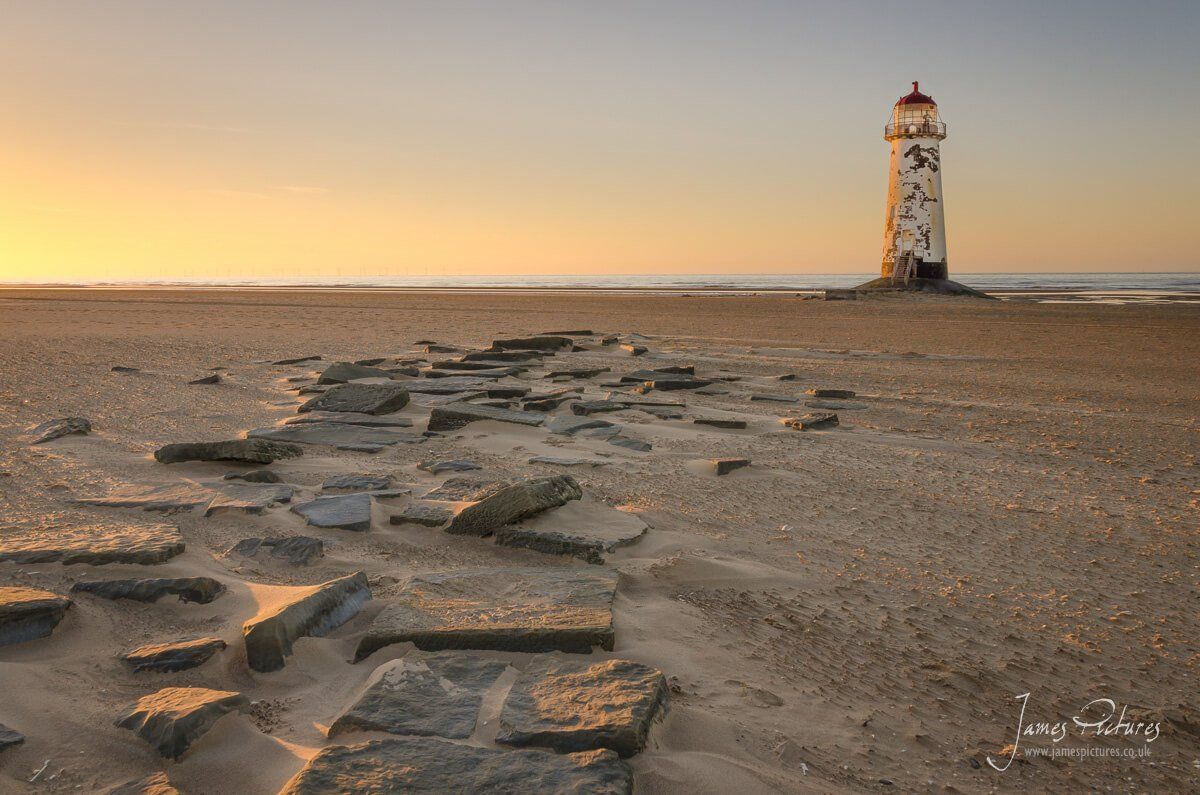 Point of Ayr Lighthouse, built in 1776, though inactive since 1844. It stands on Talacre beach, at the entrance to the River Dee estuary.