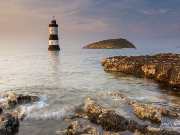 Puffin Island and Trwyn Du Lighthouse near Penmon in Anglesey North Wales with the sunset light taken in July 2013