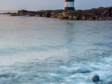 Trwyn Du Lighthouse near Penmon in Anglesey North Wales with the sunset light taken in July 2013