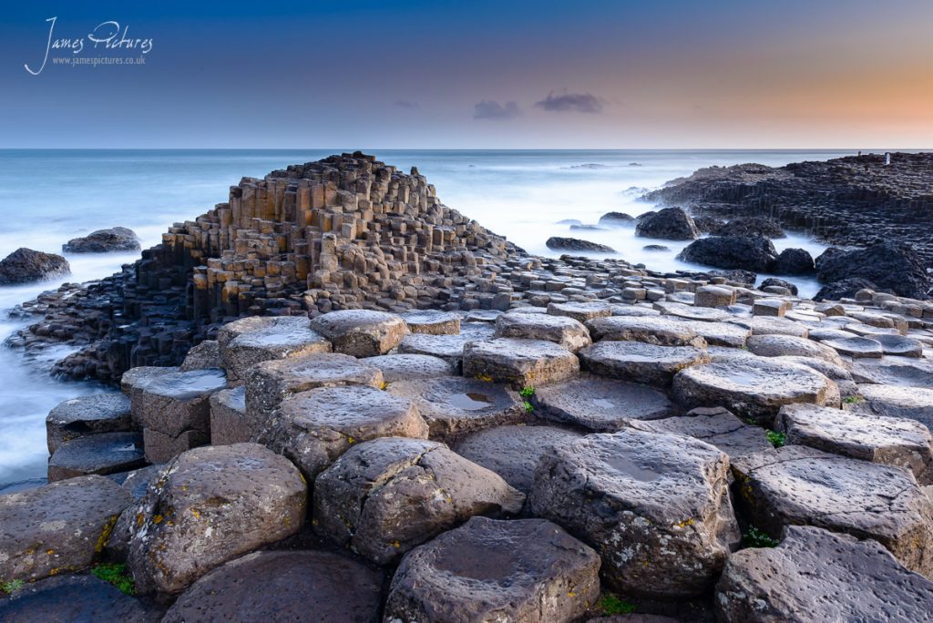 The stunning Giants Causeway in County Antrim, Northern Ireland at sunrise. a stunning creation of over 40,000 interlocking basalt columns, the result of an ancient volcanic eruption to admire.