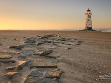 Point of Ayr Lighthouse, built in 1776, though inactive since 1844. It stands on Talacre beach, at the entrance to the River Dee estuary.